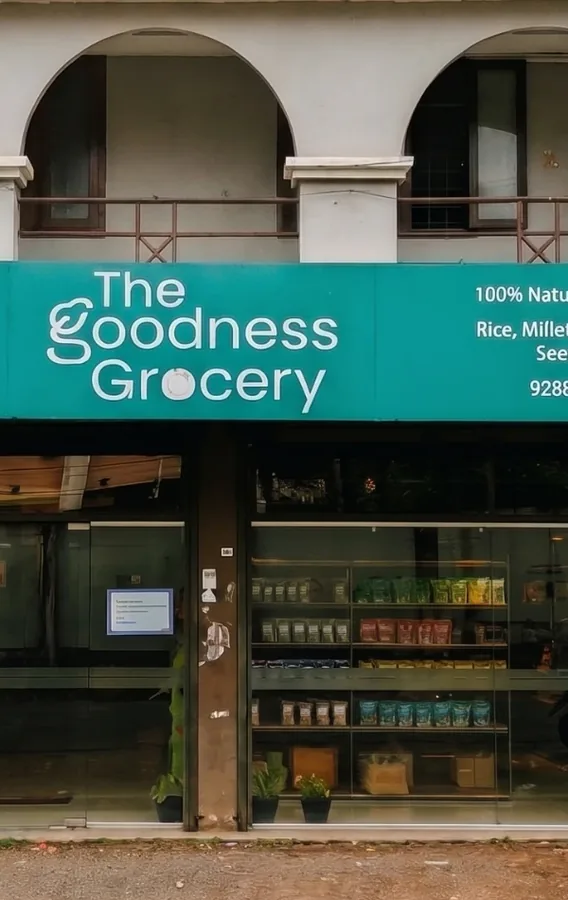The Goodness Grocery shopfront at Rajiv Gandhi Junction, Kakkanad, with shelves of millets and natural foods visible through the glass