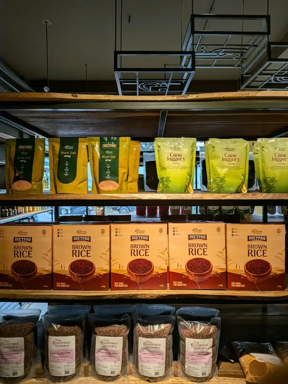 Shelves of brown rice, red rice, cane jaggery and rock salt in the shop